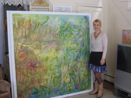 Lara Stands by one of her paintings.